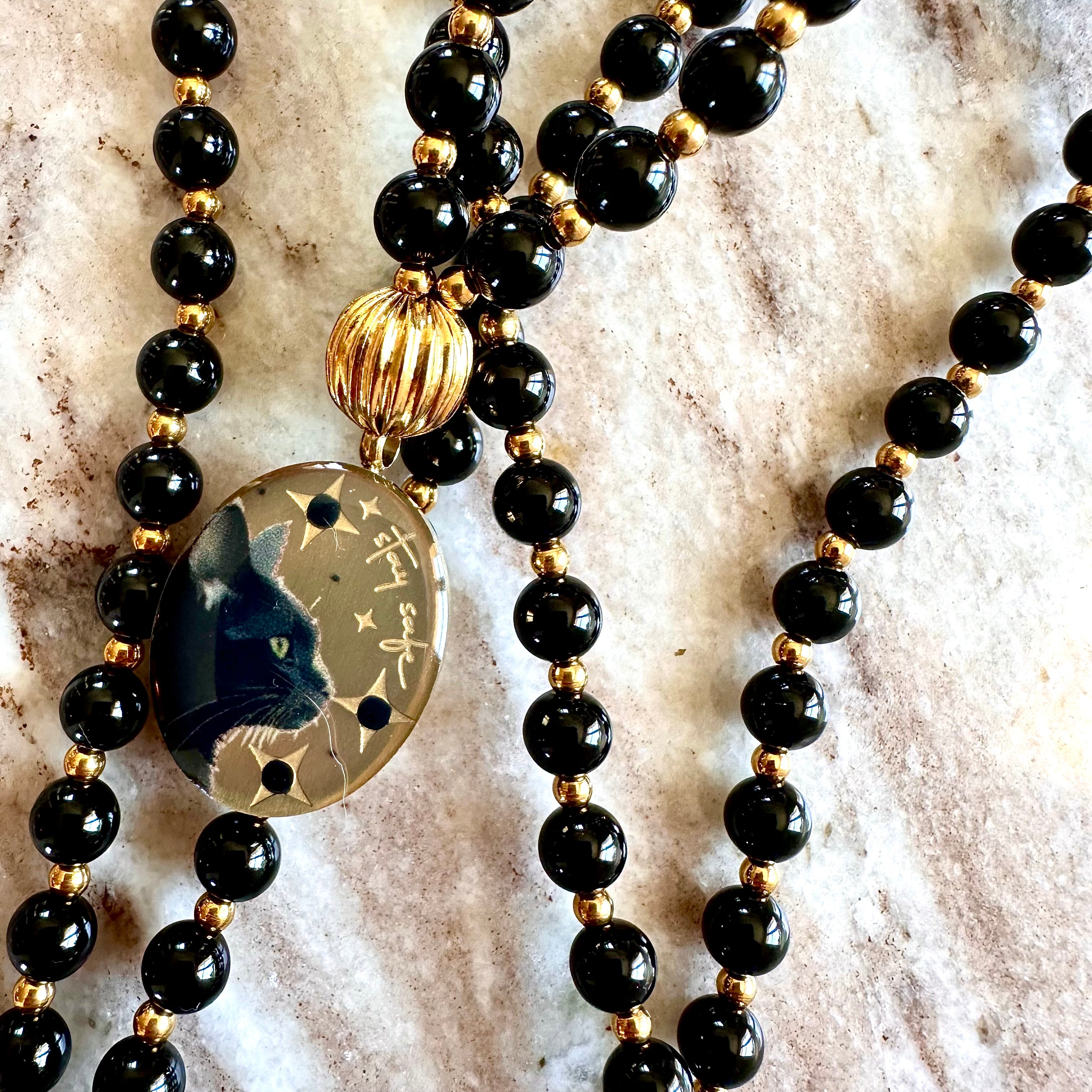 Réservation Mala précieux Protection: Le chat et Onyx noir